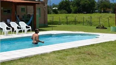 a man is standing in a swimming pool at Holiday Home Alta Vista in Mina Clavero