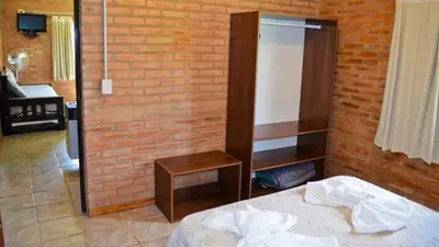 a bedroom with a bed and a brick wall at Holiday Home Alta Vista in Mina Clavero