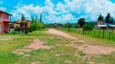 a dirt road in a field next to a house at Holiday Home Alta Vista in Mina Clavero