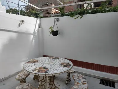 a small table sitting on a balcony with a table at Duplex Tupungato in Villa Carlos Paz
