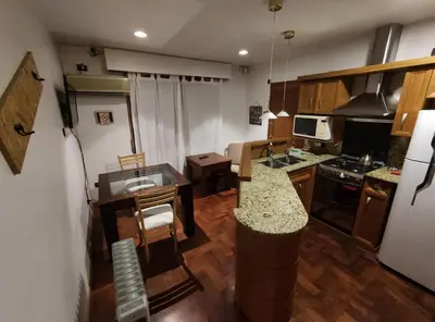 a small kitchen with a counter and a counter top at Abudé - Zona Norte, a cuadras de Sanatorio Allende Cerro, Hospital Privado y Estadio Kempes in Cordoba