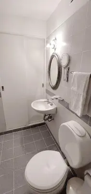a white bathroom with a toilet and a sink at Dúplex de Diseño en Nueva Córdoba in Cordoba