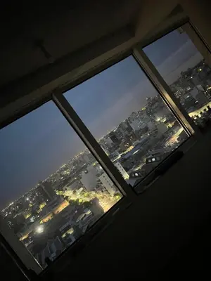 a view of a city from a window at night at Departamento PREMIUM Córdoba in Cordoba