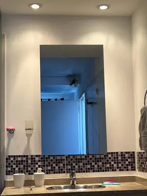 a mirror over a sink in a bathroom at Departamento PREMIUM Córdoba in Cordoba