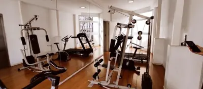 a gym with several tread machines and a mirror at Departamento PREMIUM Córdoba in Cordoba