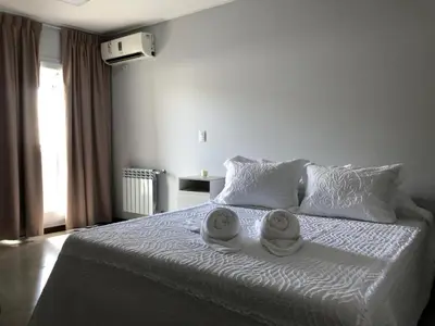 a bedroom with a bed with two towels on it at Descanso Berenice in Villa Carlos Paz