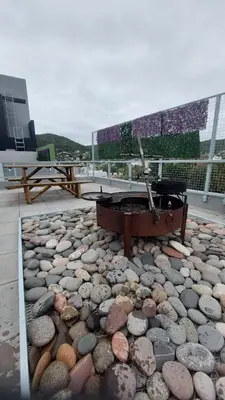 a stone patio with a piano on top of a building at Descanso Berenice in Villa Carlos Paz