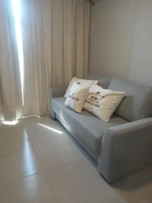 a couch in a living room with two pillows on it at Descanso Berenice in Villa Carlos Paz