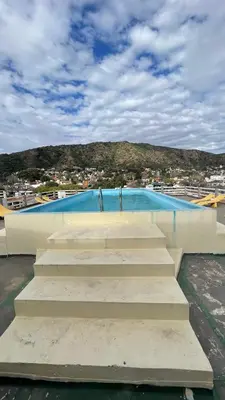 a set of stairs leading to a swimming pool at DEPARTAMENTO en VILLA CARLOS PAZ 4P in Villa Carlos Paz