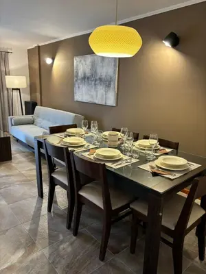 a dining room with a table with plates and wine glasses at The View in Villa General Belgrano