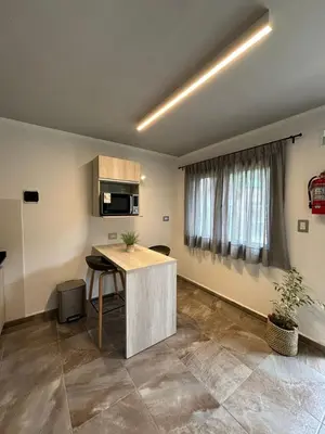 an empty room with a kitchen with a table at The View in Villa General Belgrano