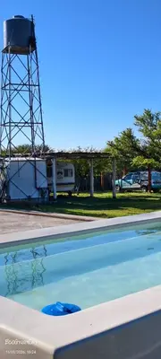 a swimming pool with a water tower in the background at Amawa Domo - escapada romántica en las sierras in San Francisco del Monte de Oro