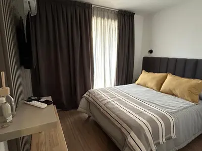 a bedroom with a large bed with a window at Departamento balcones de Cofico in Cordoba