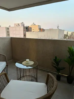 a table and chairs on a balcony with a view at Departamento balcones de Cofico in Cordoba