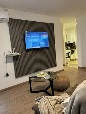 a living room with a tv on a wall at Departamento balcones de Cofico in Cordoba
