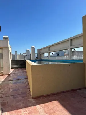 a swimming pool on the roof of a building at Departamento balcones de Cofico in Cordoba