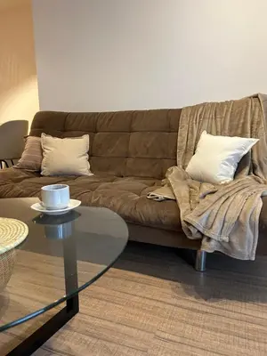 a living room with a couch and a glass table at Departamento balcones de Cofico in Cordoba