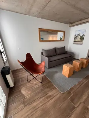 a living room with a couch and a chair at De lo mejor en Barrio General Paz in Cordoba