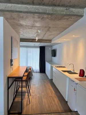 a kitchen with a table and a counter top at De lo mejor en Barrio General Paz in Cordoba