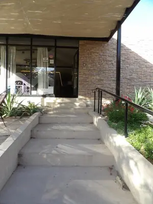 a set of concrete steps leading to a building at Nova Hotel Boutique in Villa Carlos Paz