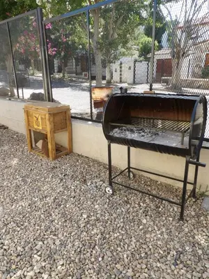 a bed and a side table next to a fence at Nova Hotel Boutique in Villa Carlos Paz