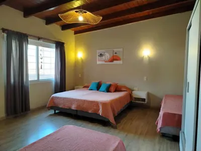 a bedroom with a bed and a large window at Dúplex 250ms Peatonal in Villa Carlos Paz