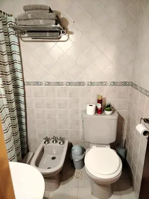 a small bathroom with a toilet and a sink at Dúplex 250ms Peatonal in Villa Carlos Paz