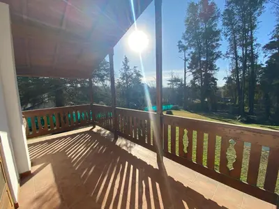 a bench on a porch with the sun shining on it at Casa RINCON DEL SOL in La Bolsa