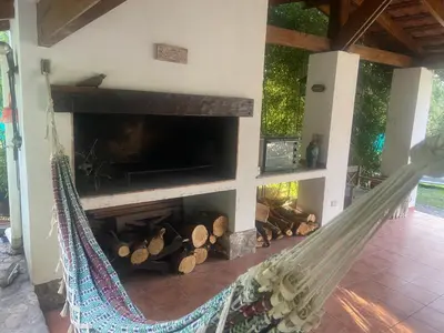 a hammock in a living room with a fireplace at Casa RINCON DEL SOL in La Bolsa