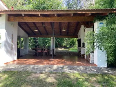 an outdoor patio with a wooden pergola at Casa RINCON DEL SOL in La Bolsa