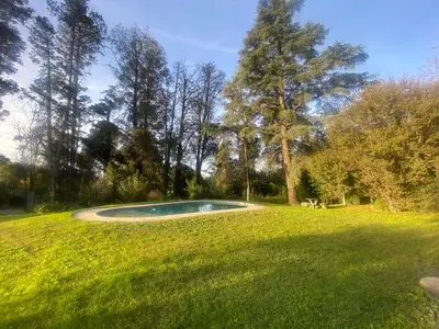 a swimming pool in the middle of a grass field at Casa RINCON DEL SOL in La Bolsa
