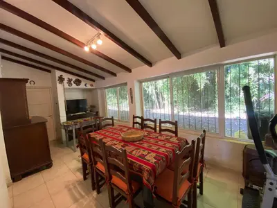 a dining room with a table and chairs and windows at Casa RINCON DEL SOL in La Bolsa