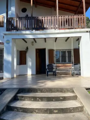 a porch of a house with a porch swing at Casa RINCON DEL SOL in La Bolsa
