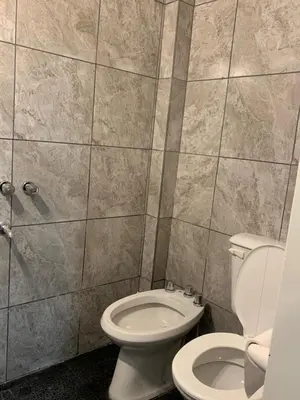 a bathroom with a toilet and a shower at Departamento Costanera in Villa Carlos Paz