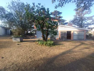 a house with a tree in the yard at Bialet Masse hermosa casa con pileta in Cordoba