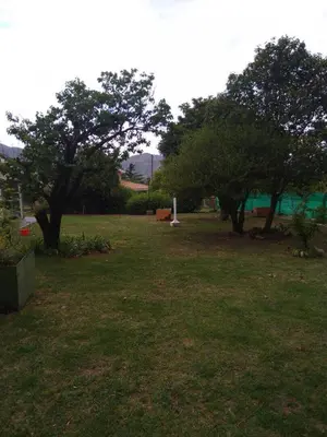 a park with trees and a field of grass at Bialet Masse hermosa casa con pileta in Cordoba