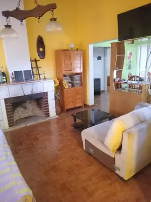a living room with a couch and a fireplace at Bialet Masse hermosa casa con pileta in Cordoba