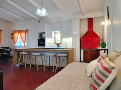 a kitchen with a bar with stools in a room at ApartQ, depto entero, Villa Belgrano, Córdoba capital in Cordoba