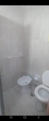a white bathroom with a toilet and a sink at Center Córdoba Nize & Cozi in Cordoba