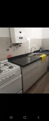 a kitchen with a white stove and a sink at Center Córdoba Nize & Cozi in Cordoba
