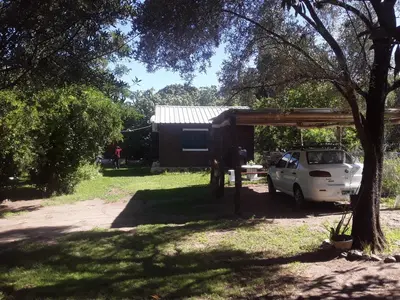 a white van parked under a shed in a yard at Cabañas La Fiaca in Los Manantiales