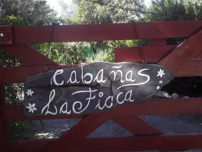 a sign on a red bench that reads adias la fabia at Cabañas La Fiaca in Los Manantiales