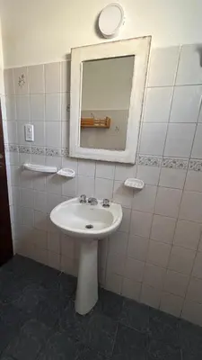 a bathroom with a sink and a mirror at 760 A Apartamentos in Alta Gracia