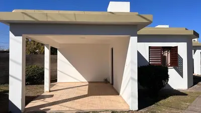 a small white house with a roof at 760 A Apartamentos in Alta Gracia