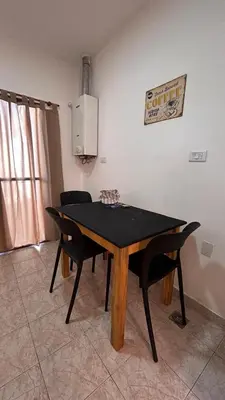 a dining room table and chairs in a room at 760 A Apartamentos in Alta Gracia