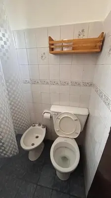 a bathroom with a toilet and a sink at 760 B Apartamentos in Alta Gracia