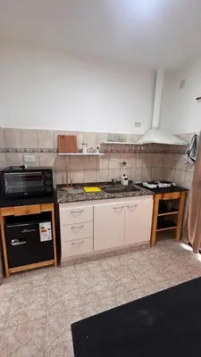 a kitchen with a sink and a stove at 760 B Apartamentos in Alta Gracia