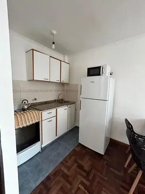 a kitchen with a white refrigerator and a sink at Departamento Nueva Cordoba in Cordoba
