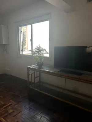 a living room with a television and a plant on a table at Departamento Nueva Cordoba in Cordoba