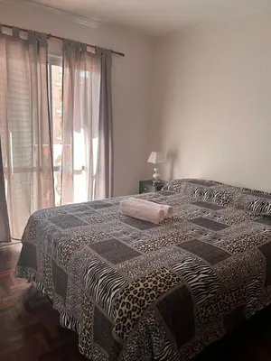 a bedroom with a bed with a blanket on it at Departamento Nueva Cordoba in Cordoba